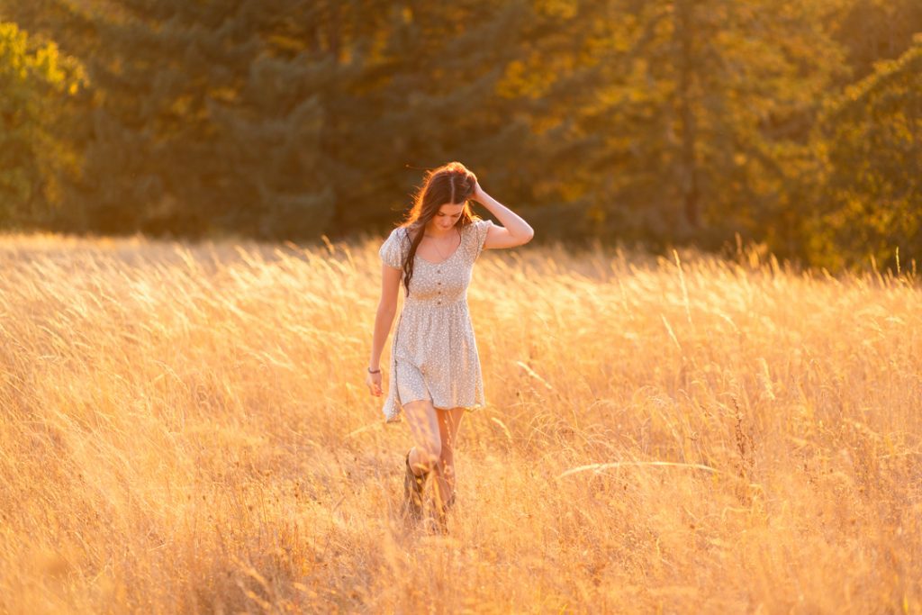 A model walks through a dreamy field taken in Corvallis, Oregon by Corvallis Portraits.